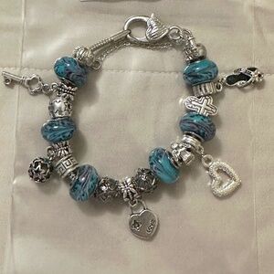 Handmade-NWOT-925SS plated charm bracelet. Blue lamp work beads. Variety charms.